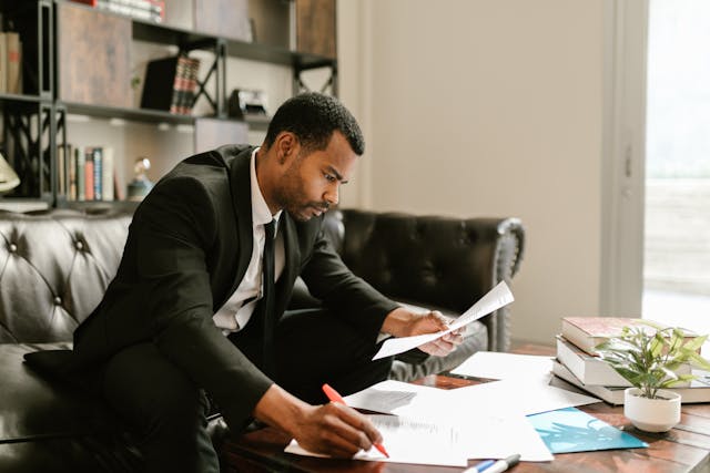 person%20sitting%20on%20a%20couch%20in%20an%20office%20looking%20at%20documents person%20sitting%20on%20a%20couch%20in%20an%20office%20looking%20at%20documents